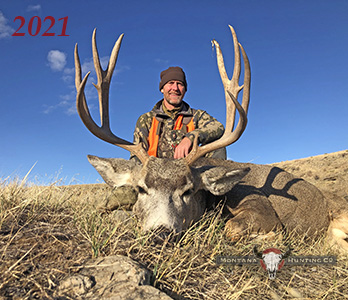 Hunter with his mule deer